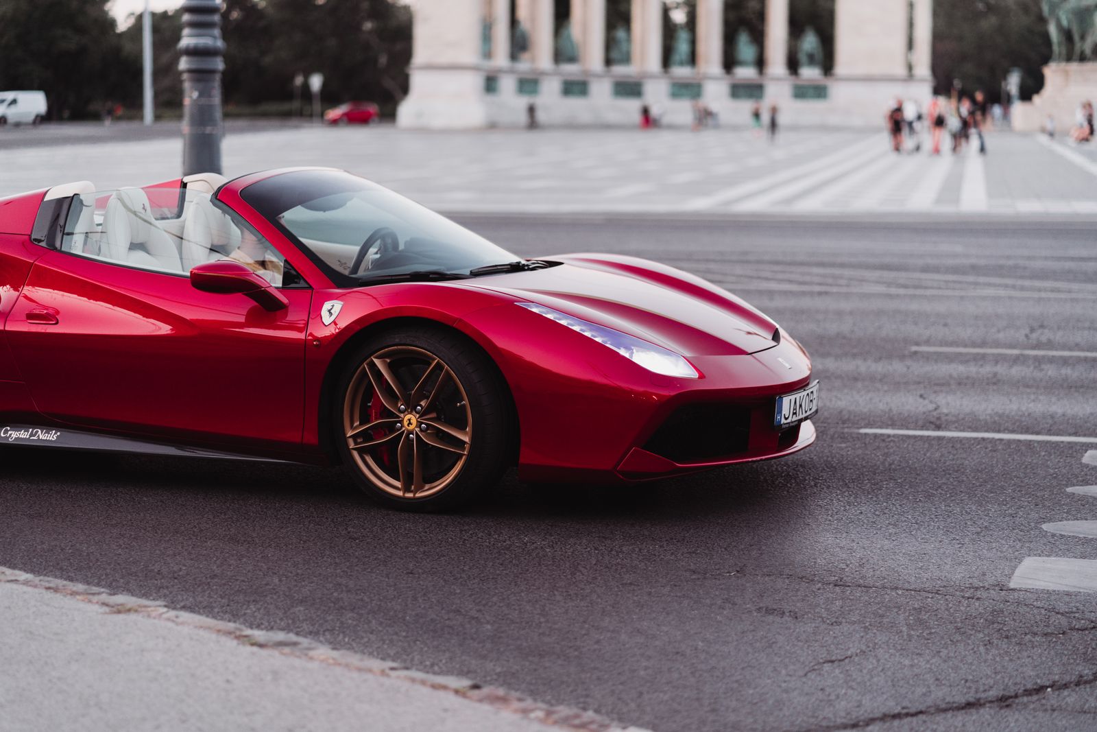 A stunning red Ferrari supercar captured on a city street, showcasing sophistication and speed.