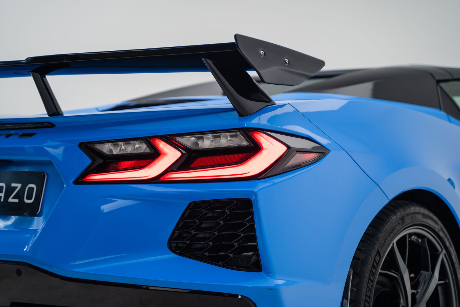 Close-up of a modern Chevrolet Corvette C8 in vibrant blue featuring its distinctive taillight design.